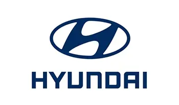 A blue hyundai logo is shown on the side of a car.